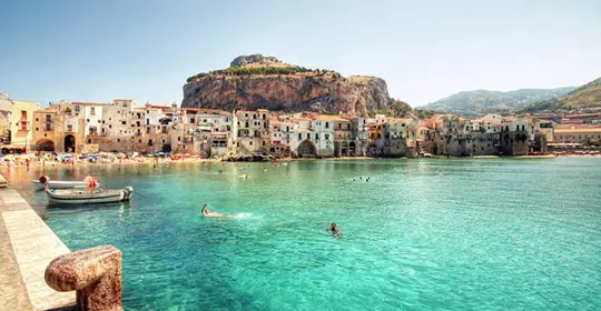 SImmers and boats in crystal clear sea