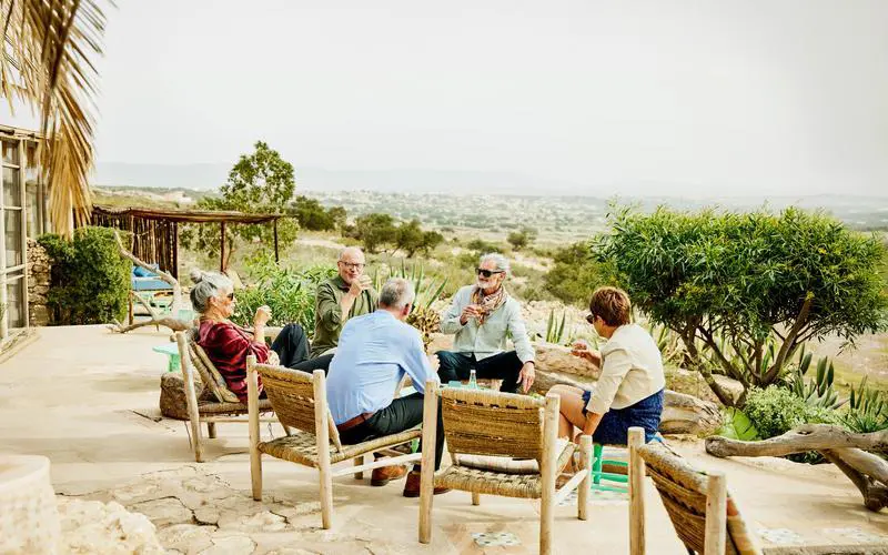 A group of solo travellers getting to know each other over some drinks